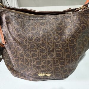 Brown monogram print hobo handbag by Calvin Klein with gold trim